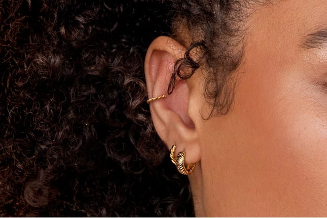 Model wearing Monica Vinader Gold Huggie Earrings